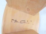 a wooden chair with writing on the back of it