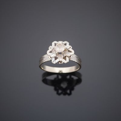 a white gold and diamond ring with a flower design