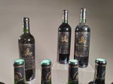 several bottles of wine are lined up on a clear shelf