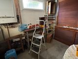 a room that has a ladder and a table in it