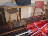an umbrella that is sitting on the ground next to a table
