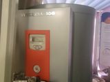 an image of a refrigerator in the corner of a room