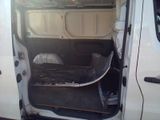 a white van with the door open and a seat in the back
