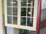 a red pole in front of a window with a red pole sticking out of it