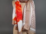 an orange and white scarf on a mannequin dummy