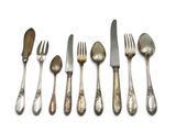 six forks and spoons are lined up on a white surface