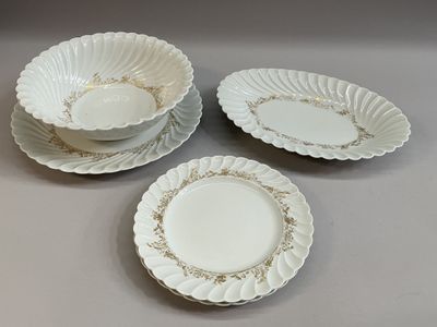 trois assiettes blanches bordées d'or sur un fond gris