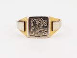 a gold and silver signet ring with the letter r on it