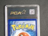a pokemon card in a plastic case on a table