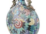a vase with a floral design on it sitting on a table