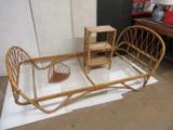 a wicker bed with a table and chairs on it