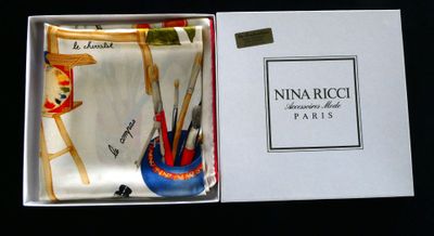 a box with a tie and a pen holder inside of it