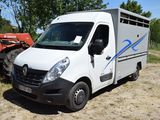 a white van that is parked in the dirt