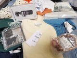 a pile of clothes and other items on a table