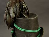 a bird that is sitting on top of a hat