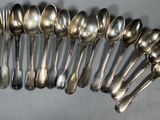 a lot of silver spoons and spoon spoons on the table