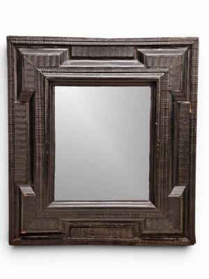 a close up of a mirror on a wall with a white background