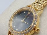 an image of a woman ' s wrist watch with a blue dial and diamond bezel