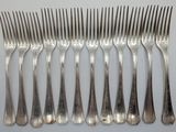 six forks that are sitting next to each other on a table
