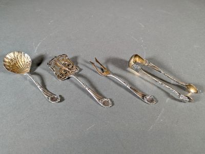 five silver spoons and two silver spoons on a table