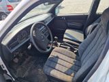 a car that is sitting in a parking lot with the door open