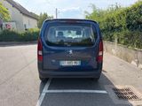 a small blue van parked on the side of the road