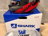 a box with a helmet on it next to a pair of shoes