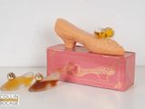 a pink box with a pair of shoes on it