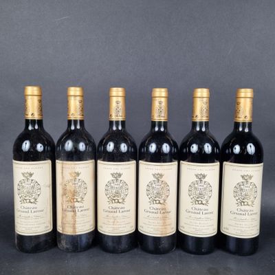 six bottles of wine are lined up in a row