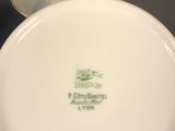 a close up of a white plate with a green logo on it