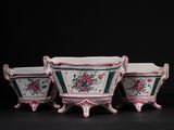 three vases with flowers on them on a table