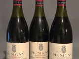 three bottles of wine are lined up on a table
