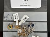 a bag of assorted jewelry on a table