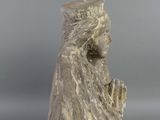 an image of a statue of a woman sitting on her knees