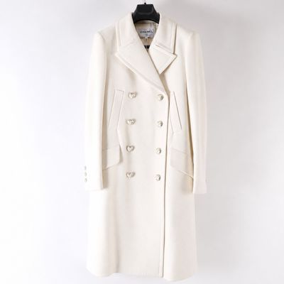 a white coat on a hanger against a white wall