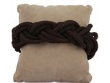 brown braided pillow with a brown pillow on it