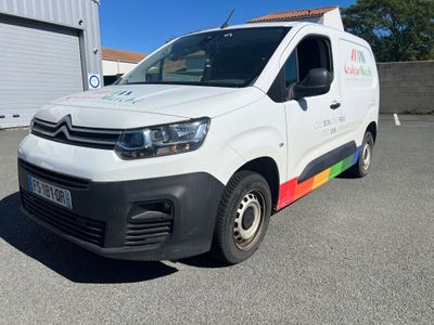 citroen van parked in a parking lot in front of a building