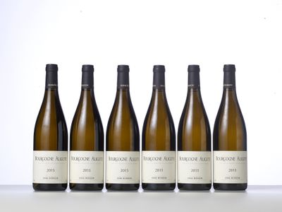 six bottles of wine lined up on a table