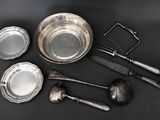 a lot of silverware on a black table