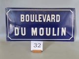 blue and white street sign sitting on top of a white table