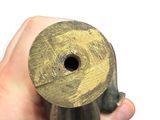 a hand holding a piece of wood with a hole in it