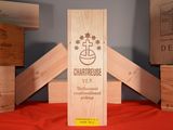 several wooden wine boxes stacked on top of each other on a table