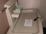 a toilet with a sign on it in a small bathroom
