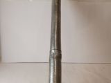 a large metal pipe with a long handle sitting on top of a counter