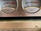 a silver radio with two different gauges on top of it