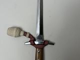 a knife with a wooden handle on a white surface