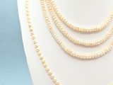 a close up of a mannequin with pearls on it