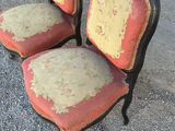 two chairs that have been painted red and yellow