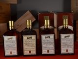 three bottles of wine sitting on top of a table next to wooden boxes
