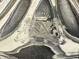 a close up of a silver plate with a crown on it